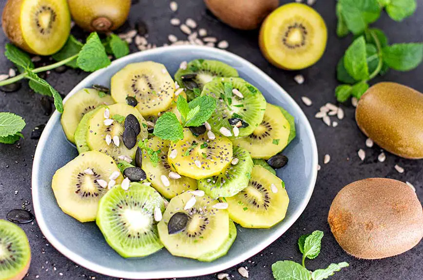 Die Nährstoffe von gelben und grünen Kiwis in einem Salat